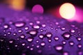 Purple light highlights close up raindrops on the windows surface