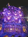 Purple lighting of the walls of Casa Batllo at night in Barcelona