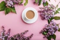 Purple lilac flowers and a cup of coffee on pastel pink background Royalty Free Stock Photo