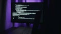Purple lit monitor with code lines, experimental prototyping environment with IDE output, creative latehour session Royalty Free Stock Photo