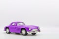 Purple little ancient model toy car isolated on background. Royalty Free Stock Photo