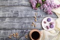 Purple macarons or macaroons cakes with cup of coffee on a gray wooden background. Top view, copy space Royalty Free Stock Photo