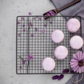Purple macaroons on a background of flowers