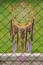 Purple macrame dream catcher with feathers on street