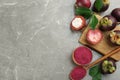 Purple mangosteen powder and fruits on grey marble table, flat lay. Space for text