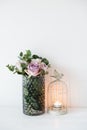 Purple, mauve color fresh summer roses in vase with white wall b