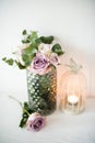 Purple, mauve color fresh summer roses in vase with white wall b