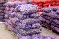 Purple mesh bags with potatoes