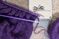 Purple mohair and alpaca yarn hand knitted sweater with stitches including stocking stitch and rib, on straight knitting needles. Royalty Free Stock Photo