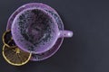 purple mug with lemon slices on black background halloween coffee pause cozy home