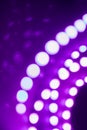 Purple neon blurry lights curls and reflections. Festive background of 80s colors