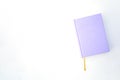 Purple notebook or book on the bright background Royalty Free Stock Photo