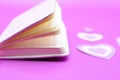 purple notebook on purple background with hearts Royalty Free Stock Photo