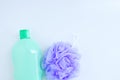 Purple nylon body scrubber and bottle of shower gel close-up on white background Royalty Free Stock Photo