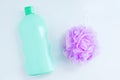 Purple nylon body washcloth and  bottle of shower gel on a white background Royalty Free Stock Photo