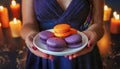 purple orange macaroons on a plate in women\'s hands