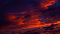 Purple orange sunset. Dramatic evening sky with clouds. Fiery sky background with space for design. Royalty Free Stock Photo