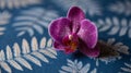 Purple Orchid on Blue Fern Pattern Background Royalty Free Stock Photo