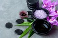 Purple orchid flower nature aromatherapy oil Spa with candle and stone spa. Thai Spa relax Treatments and massage concrete backgr