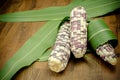 Purple organic corn on cob on wooden background Royalty Free Stock Photo