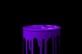 Purple paint flowing over the part of metal bucket. Isolated over black background Royalty Free Stock Photo