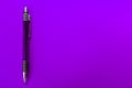 Purple pen on a purple background. Copy space. Royalty Free Stock Photo