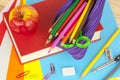 Pencil case and an apple on top of a red book Royalty Free Stock Photo