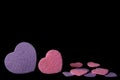 Purple and pink felt hearts isolated on a black background - valentines, love