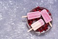 Purple - pink ice cream with berries on a gray background, top view. Frozen berry yogurt. Copy space,flat lay