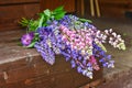 Purple - pink lupine bouquet collected in summer lies on a wooden background Royalty Free Stock Photo