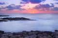 Purple and pink sunset over ocean shore Royalty Free Stock Photo