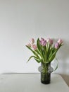 A purple and pink tulip vase at home