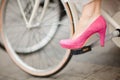 Purple - pink wedding shoe on bicycle pedal in detail