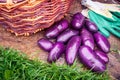 Purple potatoes, wicker basket, work protective gloves on wooden background Royalty Free Stock Photo