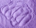 Purple powder alginate face mask, eye shadow, body wrap, hair conditioner texture close up, selective focus. Royalty Free Stock Photo