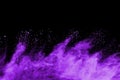 Purple powder explosion on black background.
