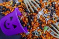 Halloween candy spilling out of purple pumpkin bucket