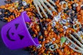 Halloween candy spilling out of purple pumpkin bucket