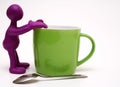 Purple puppet of plasticine rest on cup