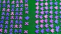 Purple puzzle pieces sorted on a green table cloth Royalty Free Stock Photo