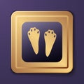 Purple Rabbit and hare paw footprint icon isolated on purple background. Gold square button. Vector