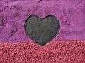 purple and red padded door mat with black heart symbol