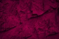 Purple red rock background for design. Dark cherry plum shade. Toned mountain surface.