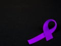 Purple ribbon awareness on black background . Royalty Free Stock Photo