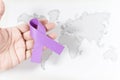 Purple ribbon on a person's hand - awareness of violence against women concept Royalty Free Stock Photo