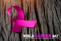 Purple ribbon on wooden background for World Cancer day Royalty Free Stock Photo