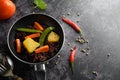 Purple rice berries with peas Pumpkin leaves, carrots and mint leaves in a frying pan Royalty Free Stock Photo