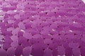 Purple rubber mat for bath with pattern as background, imitation of stone Royalty Free Stock Photo