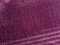 purple rug with soft fur that looks luxurious to the touch. a sloping pattern in a diagonal line.