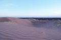 Purple sand dunes in the desert at dusk, a few minutes after sunset. Royalty Free Stock Photo